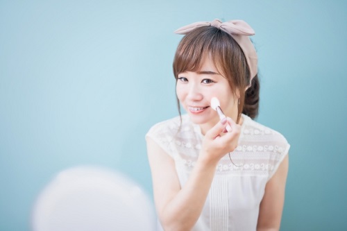 フェイスパウダーを重ねる40代女性