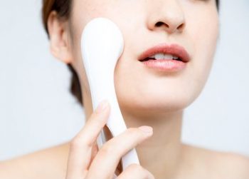 ほうれい線対策のために美顔器を使う女性