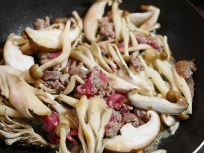 きのことひき肉を炒める様子